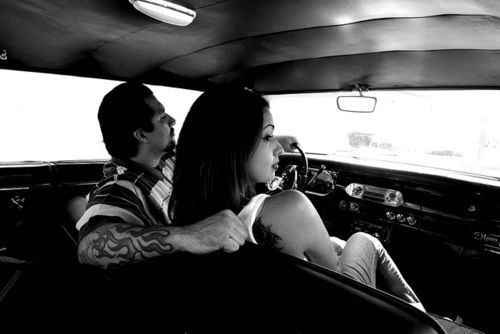 A couple riding together in a classic lowrider