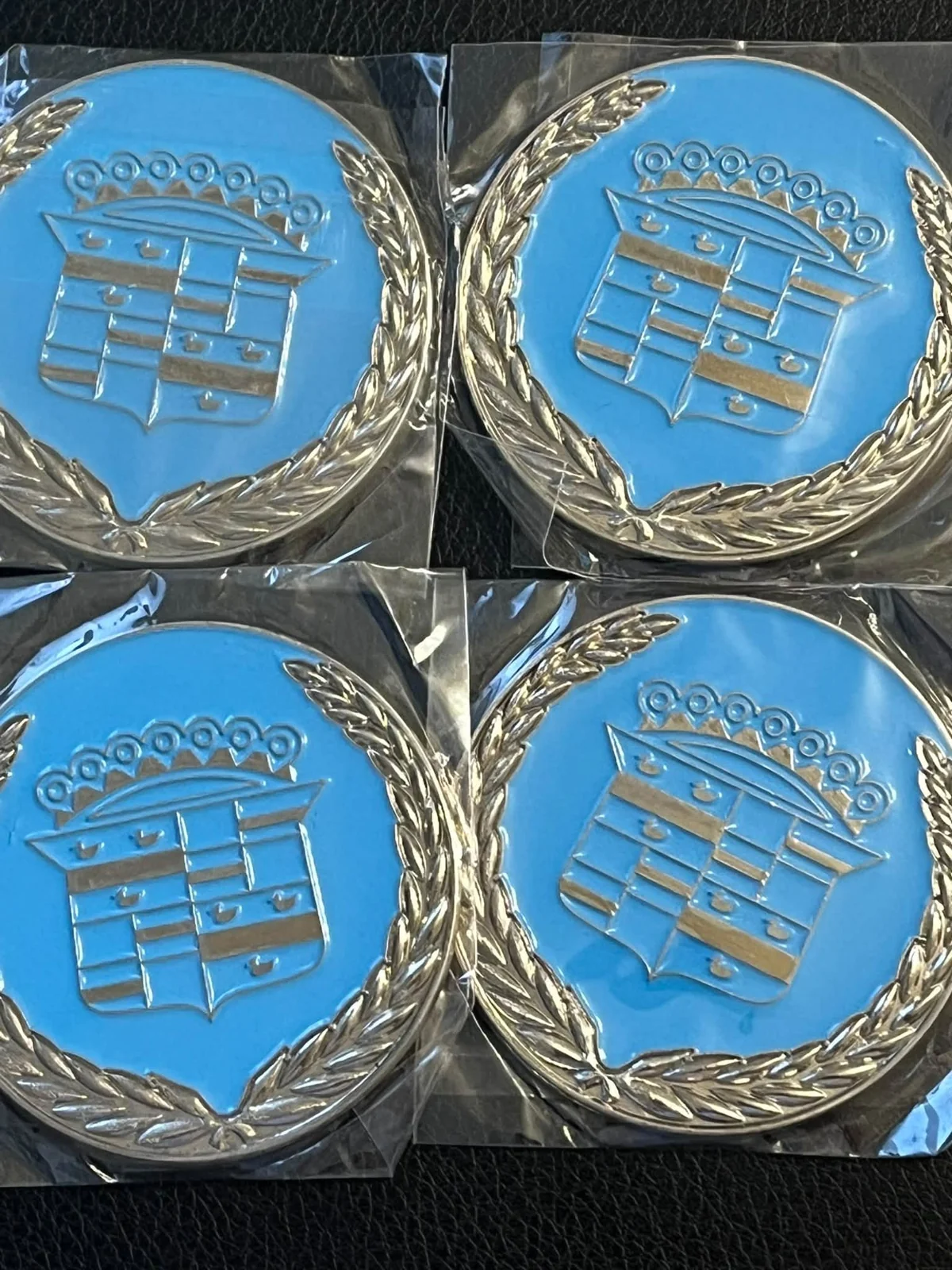 Cadillac crest — blue lowrider wire-wheel chips